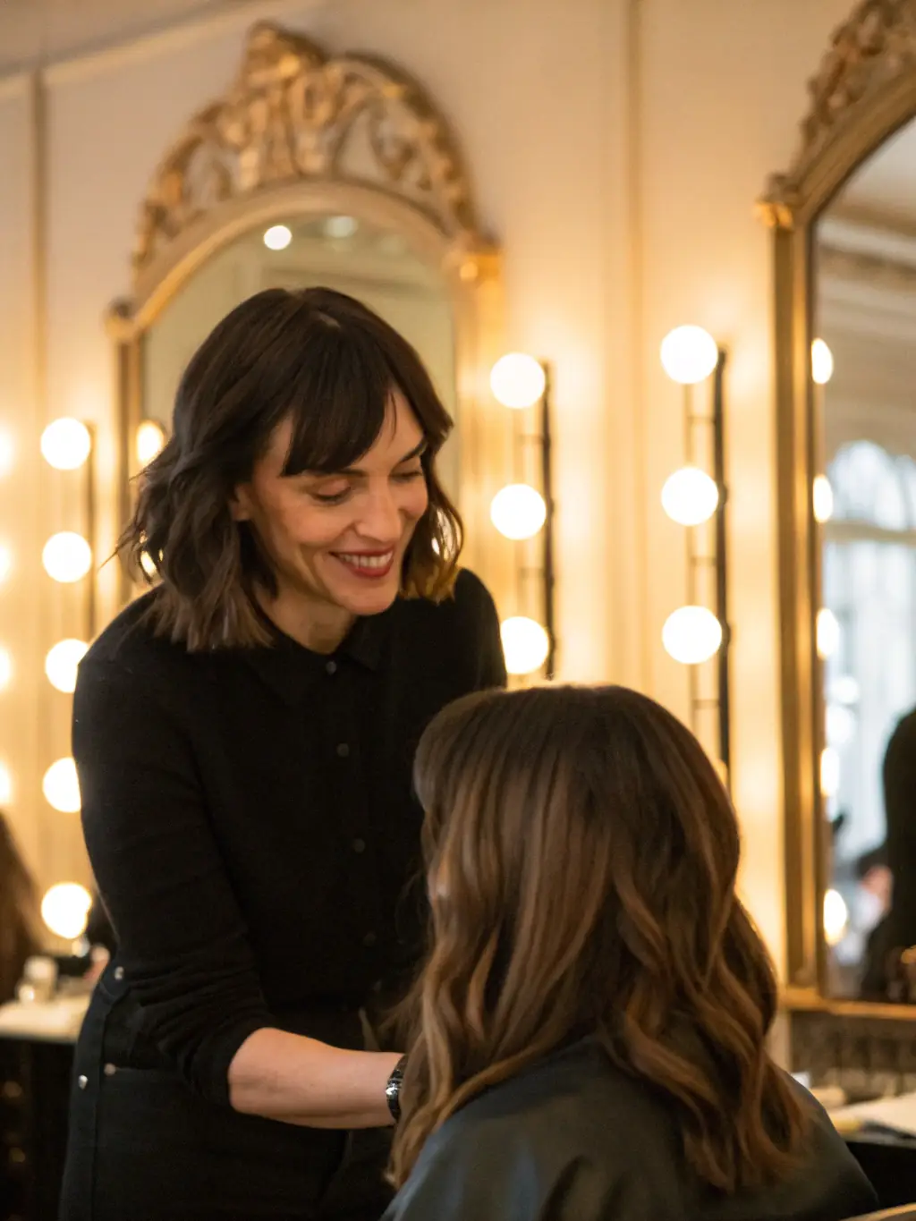 A client receiving a personalized hair consultation from Georgia Mitchell, discussing their hair goals and styling preferences.